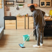 Young Man Cleaning Floors at Home